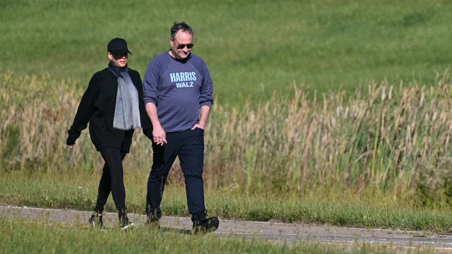 Vice President Kamala Harris walks alongside her husband, Doug Emhoff 