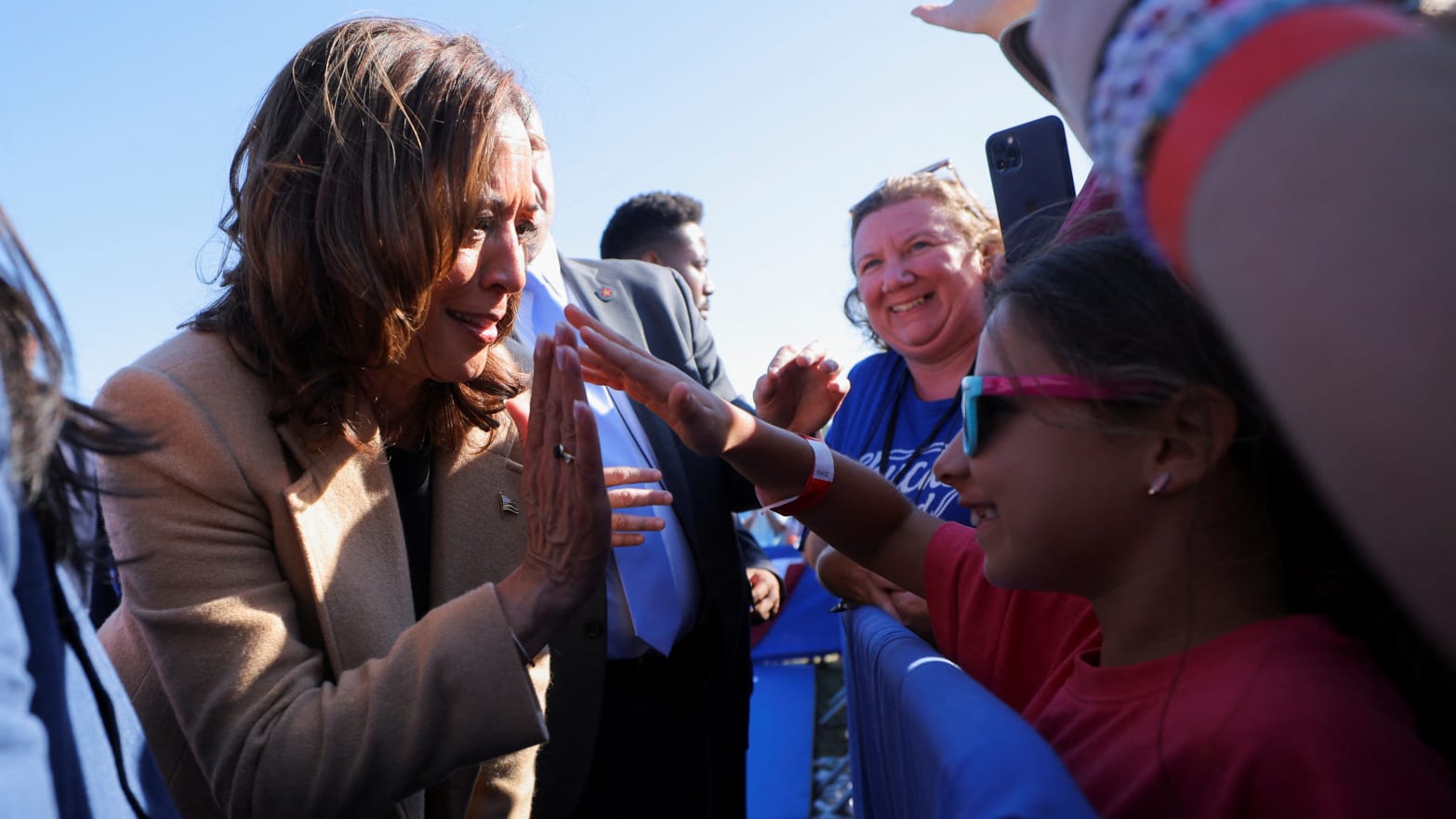 Democratic presidential nominee and U.S. Vice President Kamala Harris high-fives Charlotte Husid, 8, during a campaign stop in North Hampton, New Hampshire.