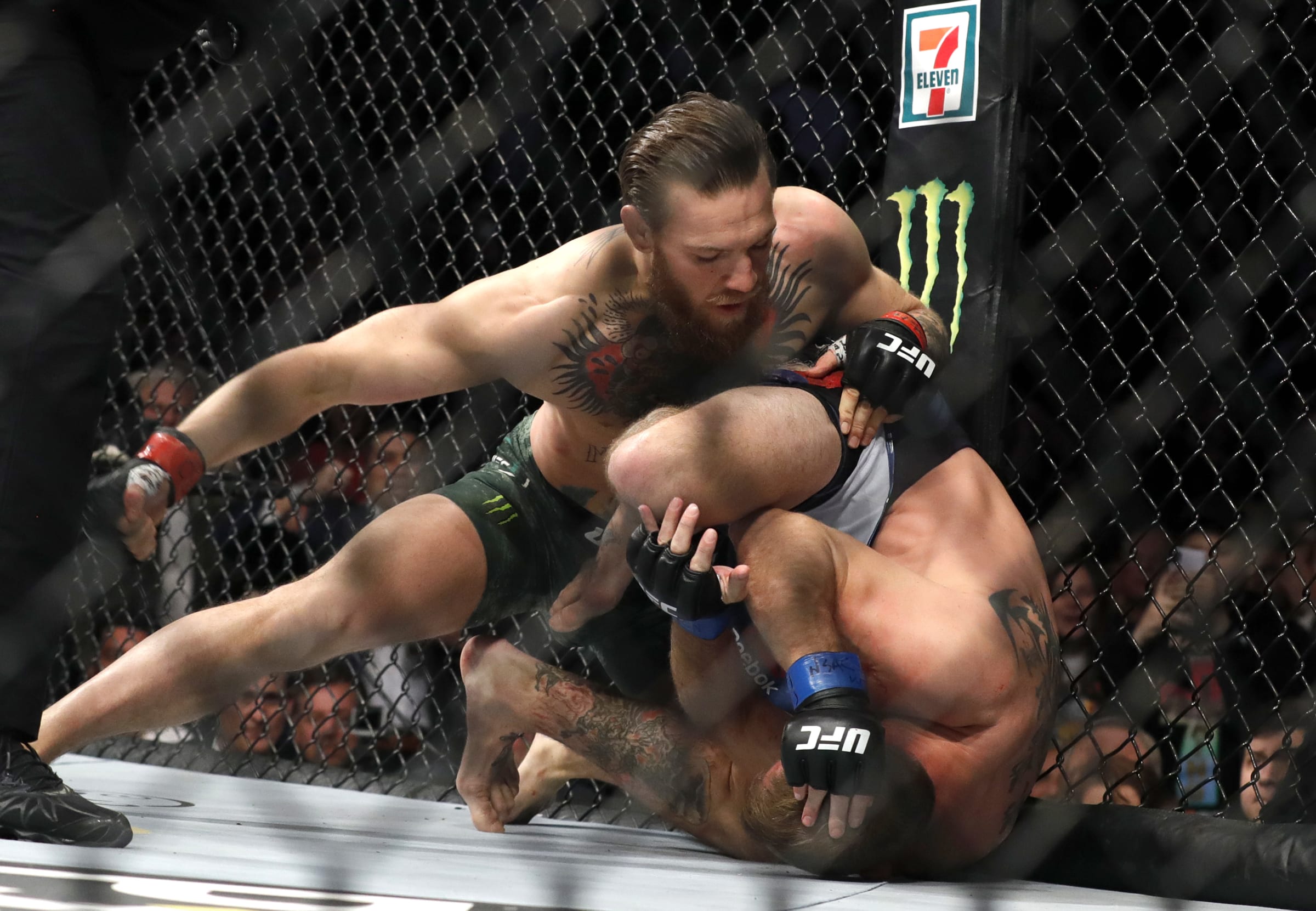 Conor McGregor punches Donald Cerrone in a welterweight bout during UFC246 ...