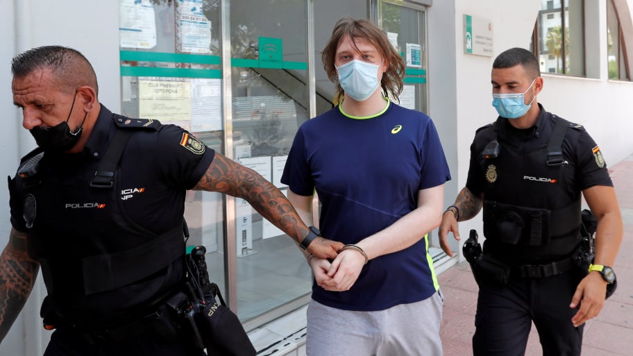Joseph James O'Connor is led by Spanish police officers as he leaves a court after being arrested in connection with an alleged July 2020 Twitter hack in Estepona, Spain, July 22, 2021. 