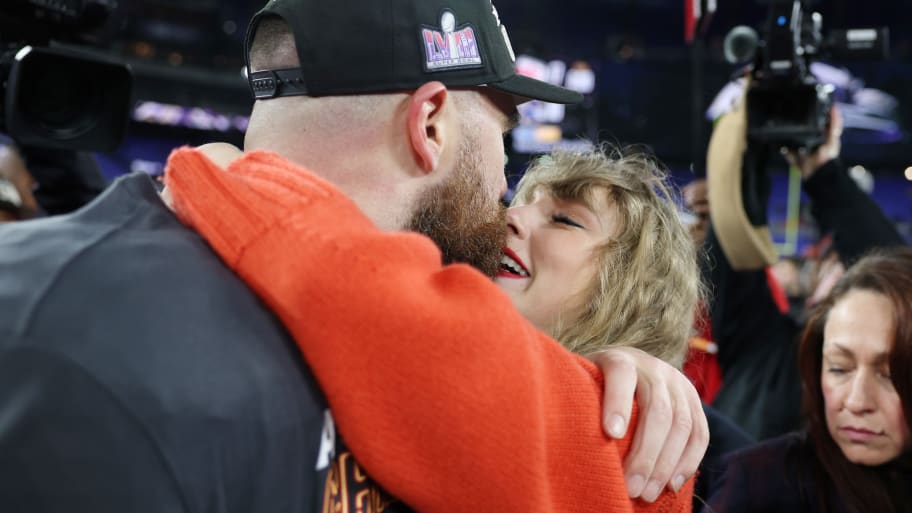 Travis Kelce of the Kansas City Chiefs celebrates with his girlfriend, Taylor Swift, after a 17-10 victory against the Baltimore Ravens in the AFC Championship Game.