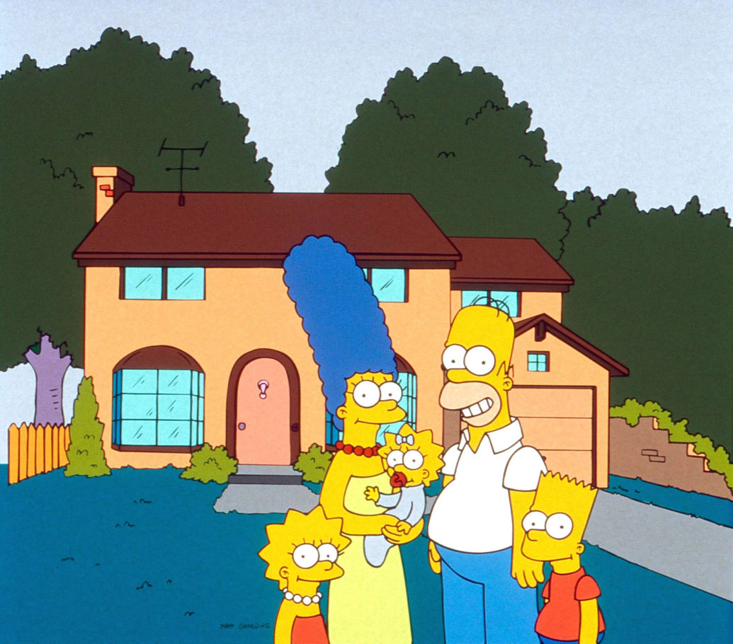 A still of a 90s episode of The Simpsons shows the entire Simpsons family posing outside of their house.