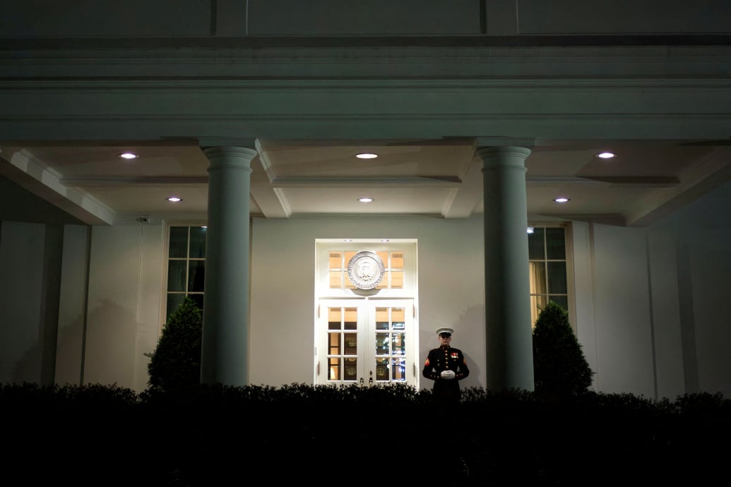 A Marine stands outside the West Wing of the White House 
