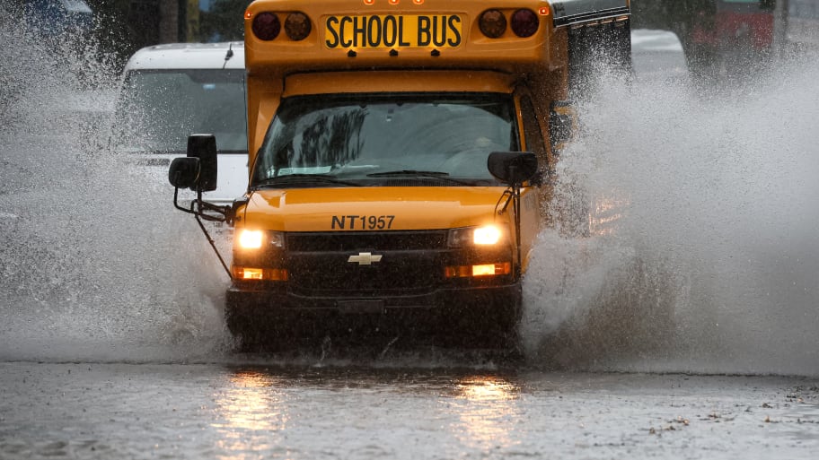 A school bus drives on a flooded street, as the remnants of Tropical Storm Ophelia bring flooding across mid-Atlantic and Northeast, in the Brooklyn borough of New York City.