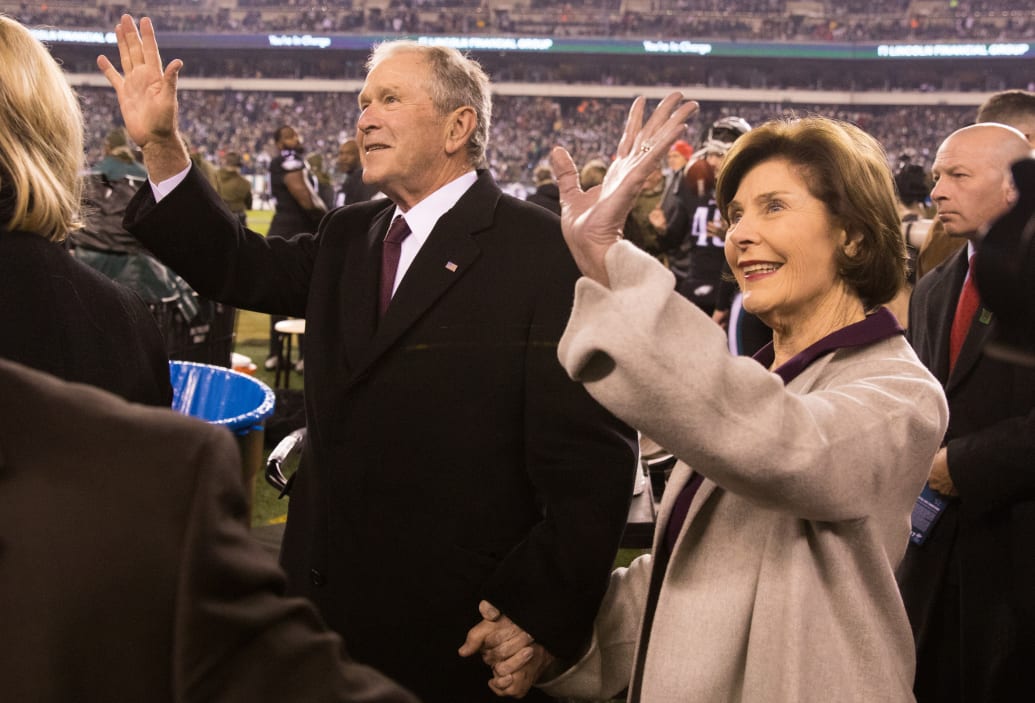 George W. Bush and his wife Laura Bush on the field before an NFL game in 2018.