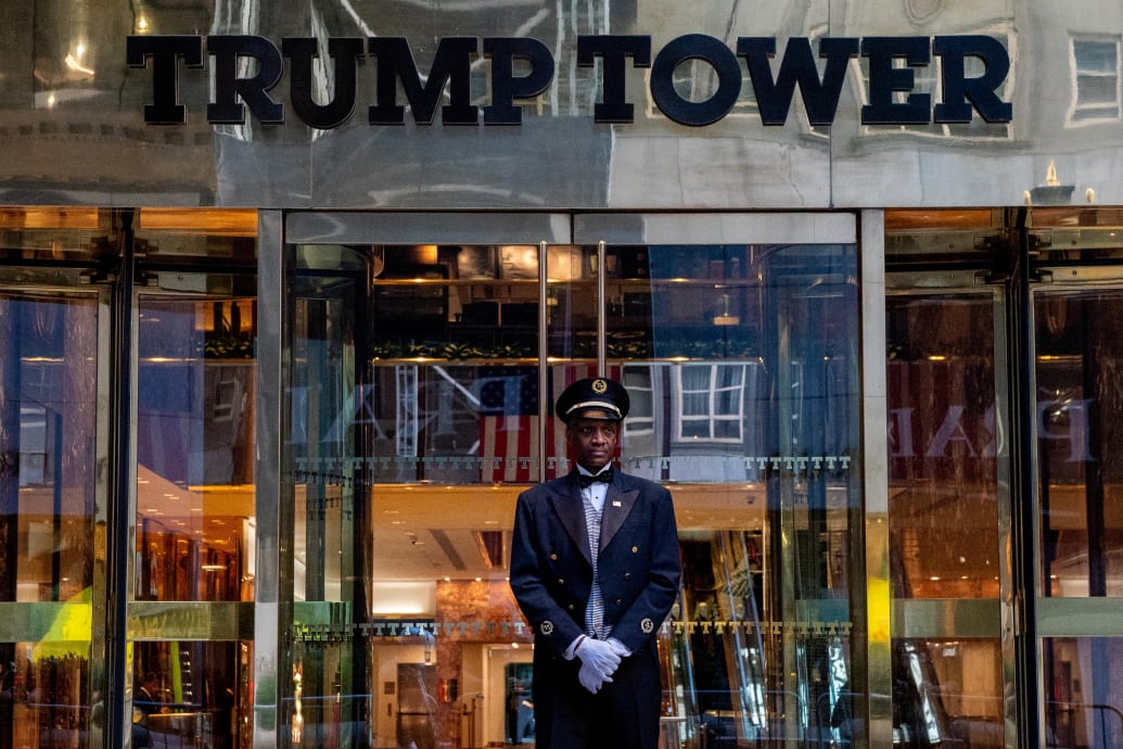 A door man stands at the entrance to Trump Tower.