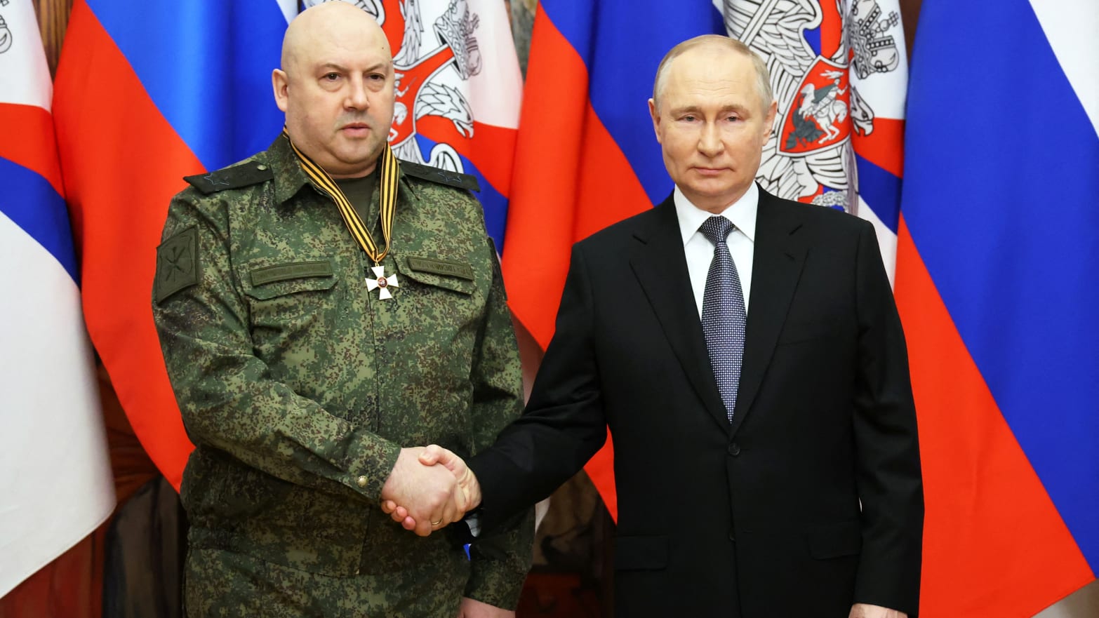 Russian President Vladimir Putin awards General Sergei Surovikin, commander of Russian forces in Ukraine, with the Order of St. George, Third Class, at the headquarters of the Southern Military District in Rostov-on-Don, Russia, Dec. 31, 2022. 
