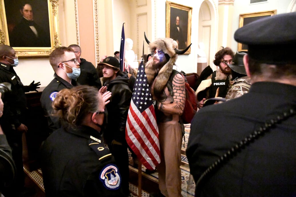 Jacob Chansley and other rioters confronted by police in the Capitol on Jan. 6.
