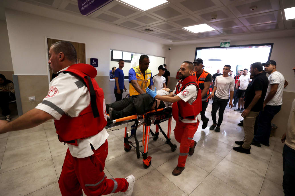 A photograph of an injured Palestinian on a stretcher being brought into the emergency room in the West Bank.