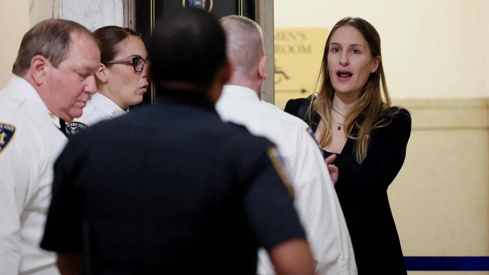 A woman talks with court officers as she is detained outside Donald Trump’s fraud trial in New York.