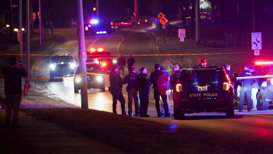 Police officers surround a scene where the suspect was located as they respond to a shooting at Michigan State University in East Lansing, Michigan, U.S., February 14, 2023.   