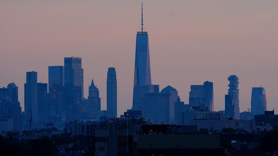 A general view as the sun sets behind the New York City skyline.