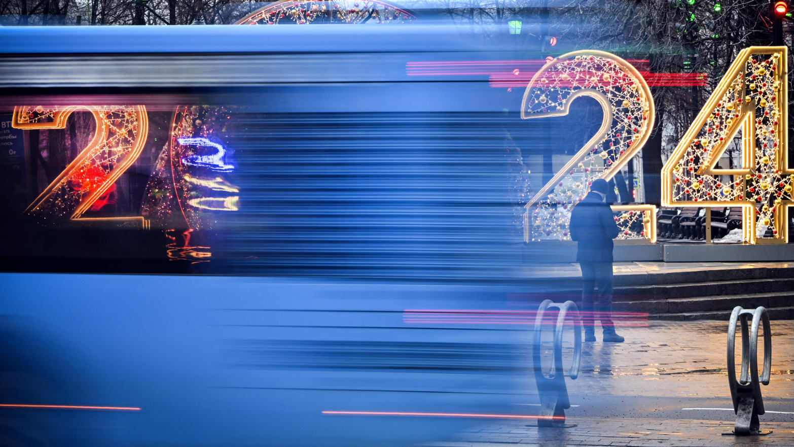 A bus drives past a New Year 2024 numerals decoration in central Moscow on Dec. 31, 2023.