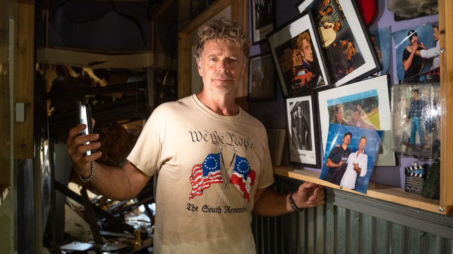 Actor John Schneider, known for his role as Bo Duke in \"The Dukes of Hazzard\" television series, stands inside his studio that was damaged by Hurricane Ida on September 2, 2021 in Holden, Louisiana