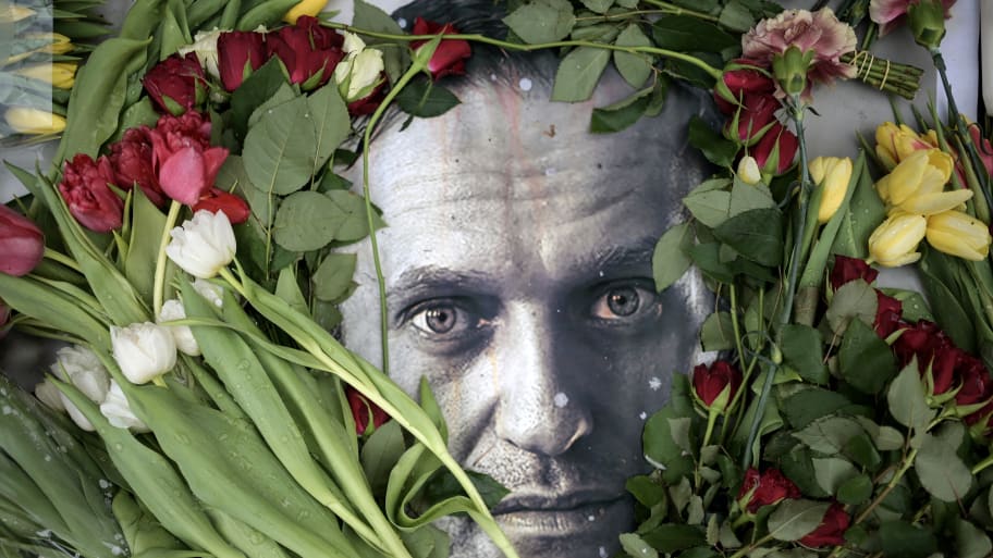 Flowers are seen placed around a portrait of late Russian opposition leader Alexei Navalny.