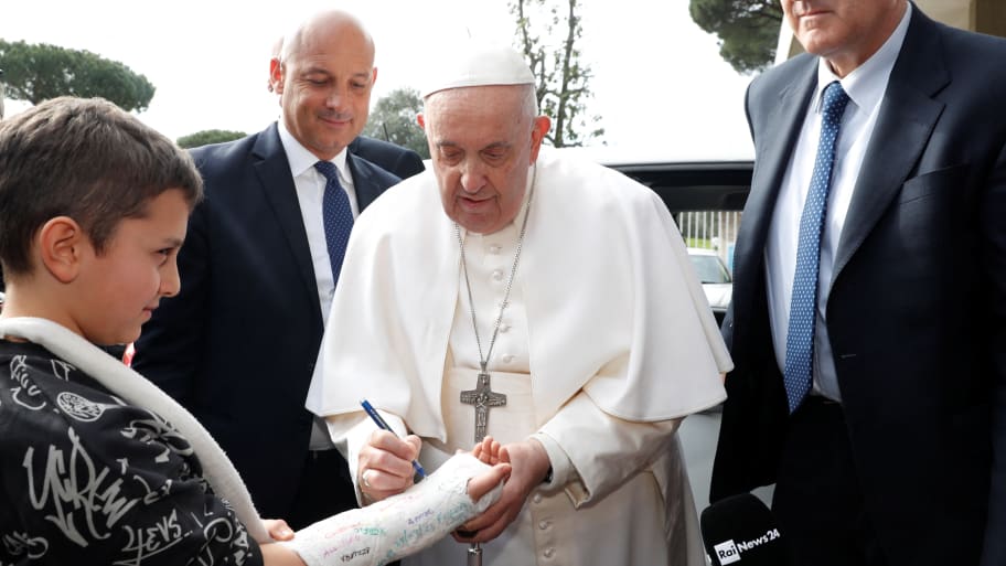Pope Francis writes on boy's cast as he leaves Rome's Gemelli hospital in Rome, Italy, April 1, 2023.
