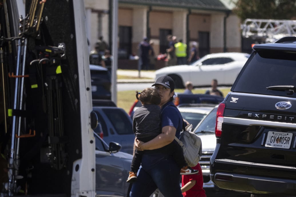 Parents arrive to pick up their children after a shooting took place at Apalachee High School.