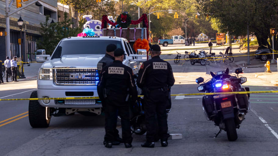 Police officers work the scene after a truck pulling a float crashed at a holiday parade in Raleigh, N.C., on Saturday, Nov. 19, 2022. 