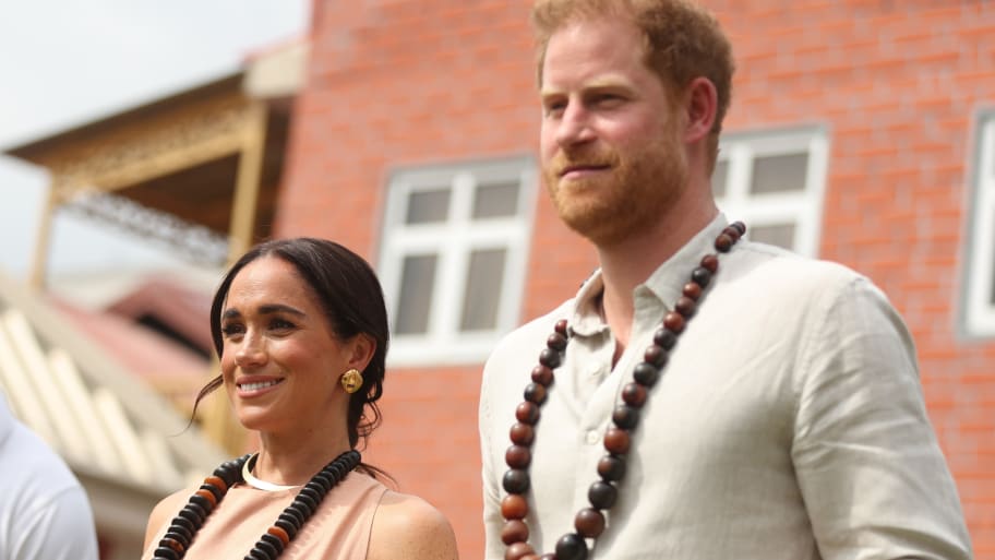 Duke of Sussex Prince Harry (R) his wife Meghan Markle (L), Duchess of Sussex, visit the Lightway Academy in Abuja, Nigeria.