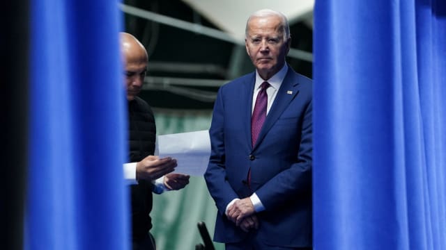 President Joe Biden stands next to aide Ryan Montoya as he prepares to deliver remarks on lowering costs for American families during a visit to Goffstown, New Hampshire.