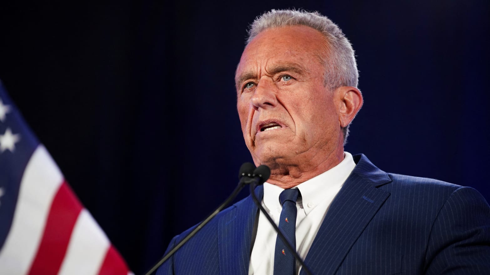 Robert F. Kennedy Jr. speaks in Phoenix behind a podium.