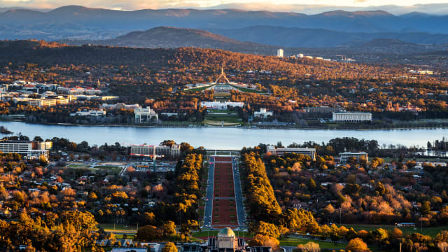 A scenic photograph of Canberra, Australia with mountains in the distance.