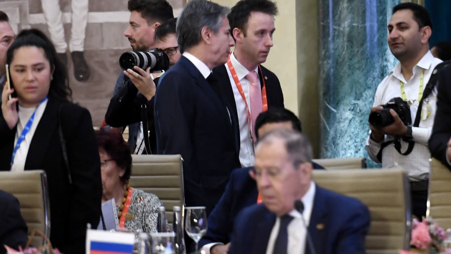 U.S Secretary of State Antony Blinken (top L) walks past Russian Foreign Minister Sergei Lavrov (lower) during the G20 foreign ministers’ meeting in New Delhi on March 2, 2023.  