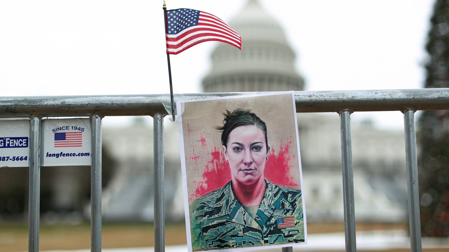 A portrait of Ashli Babbitt who was shot dead during the January 6, 2021 attack on the U.S. Capitol, hangs on a fence outside the Capitol, in Washington, D.C.