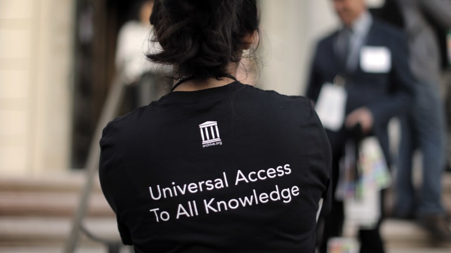 A staff member wears a "Universal Access to All Knowledge" shirt during a 20th anniversary celebration of the Internet Archive in San Francisco.