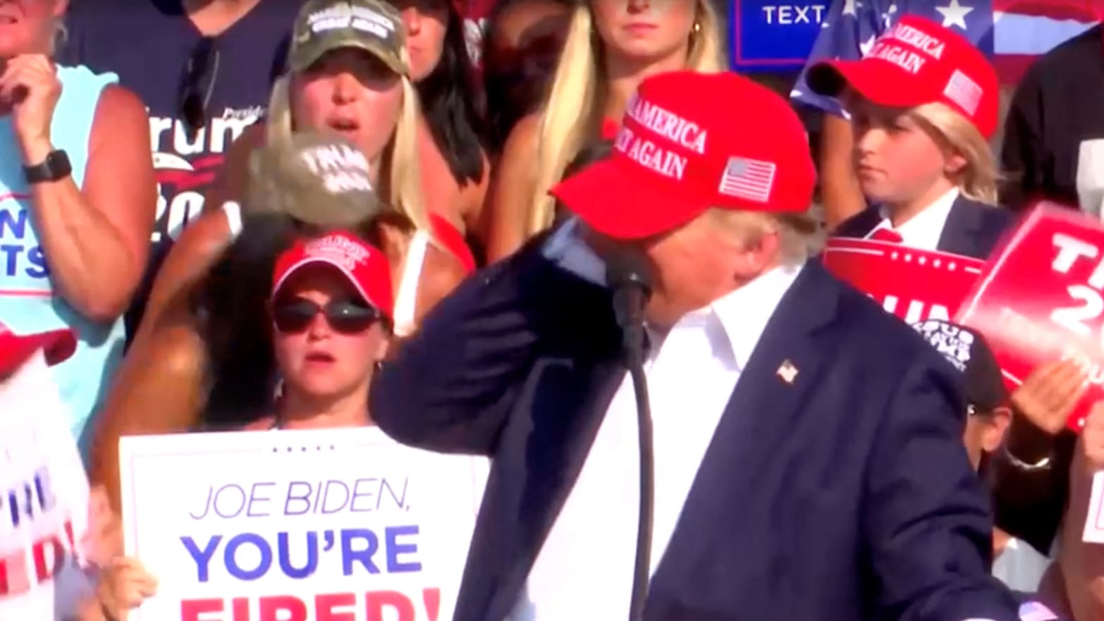 Donald Trump with his hand to his ear during the attempted shooting