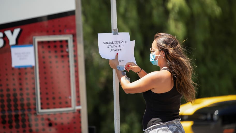 A woman puts up a COVID sign.