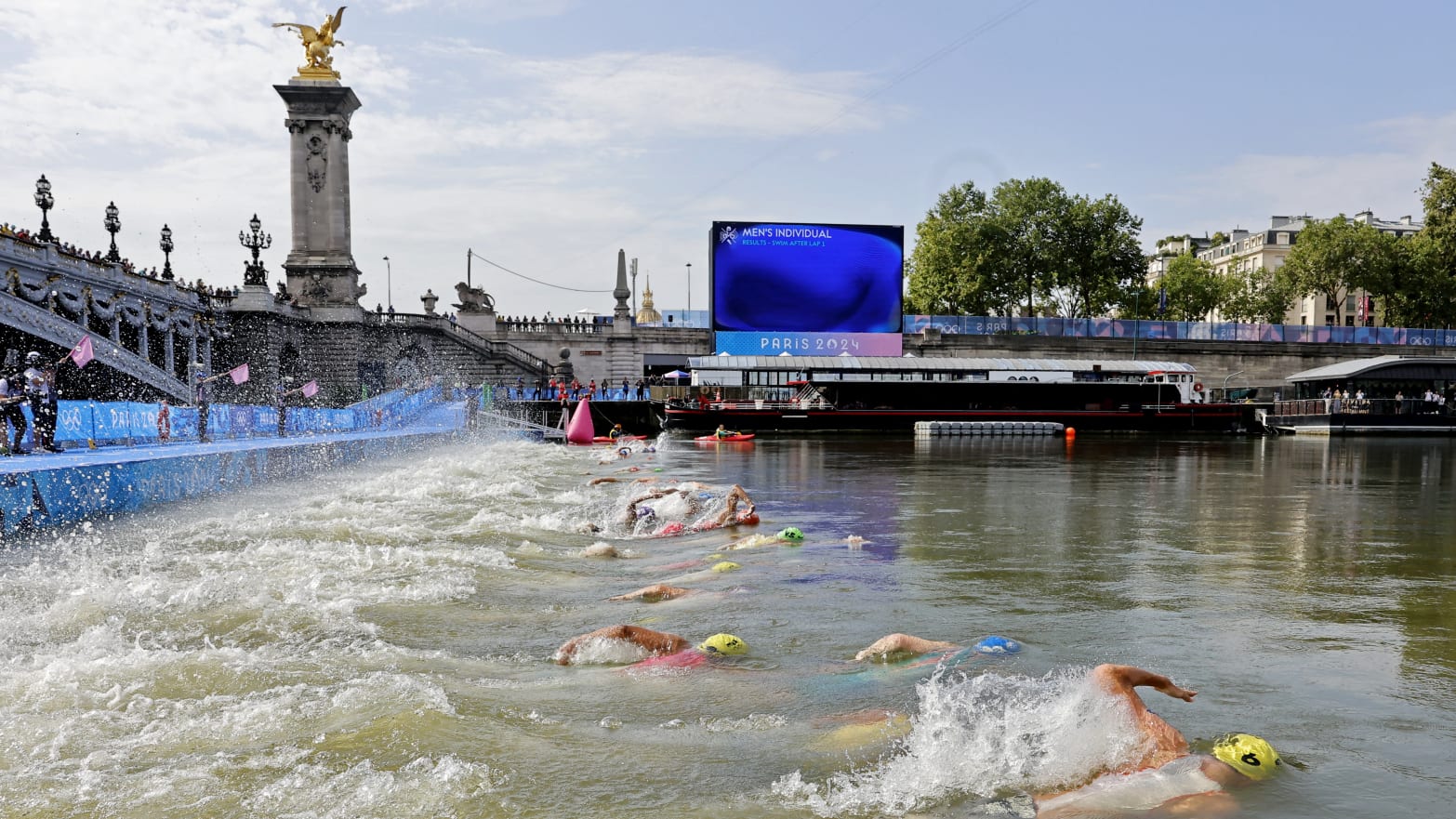 Athletes had to swim 1500 meters in the murky Seine water.