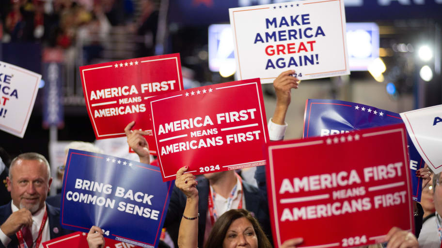 Attendees holding signs at the Republican National Convention