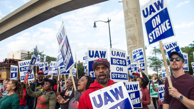 Protesters march through the streets of downtown Detroit amid UAW strike