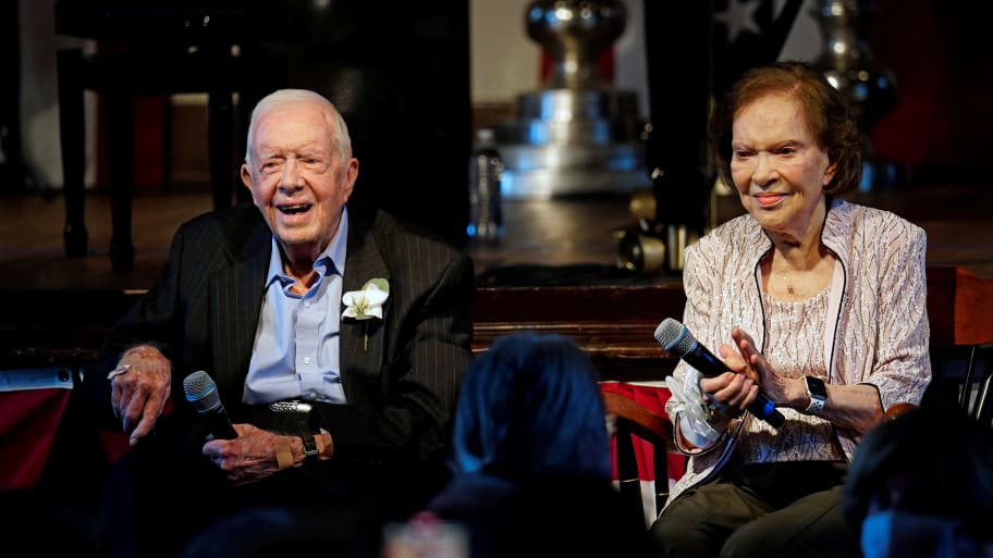 Jimmy Carter and his wife, former first lady Rosalynn Carter sit together during a reception to celebrate their 75th wedding anniversary