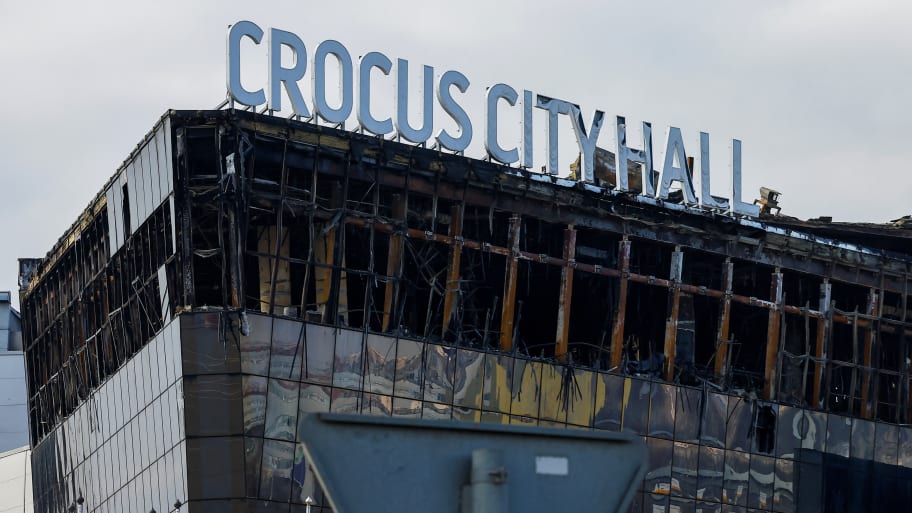 A partially-burned Crocus City Hall during the day time.