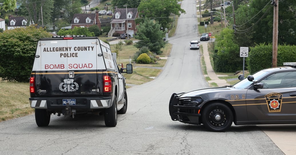 Allegheny County Bomb Squad vehicle seen on a road with police car beside it