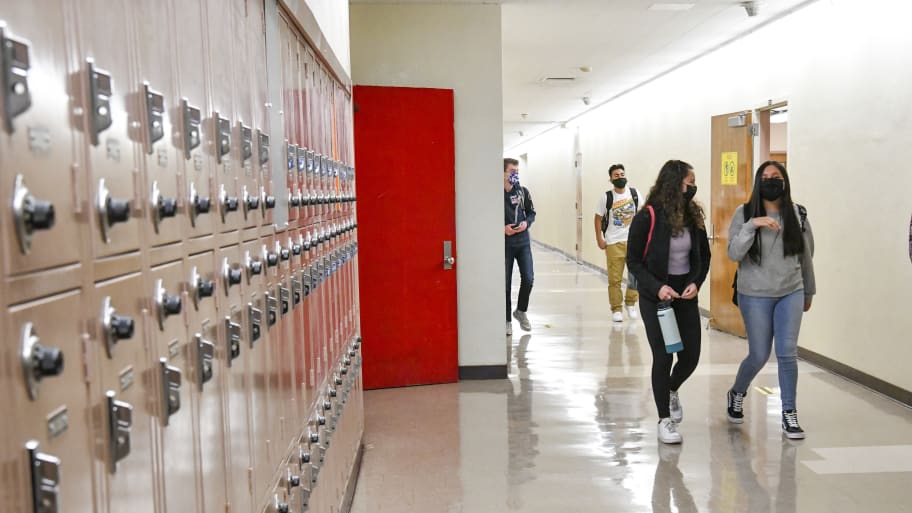 Returning students walk the hallway at a High School.