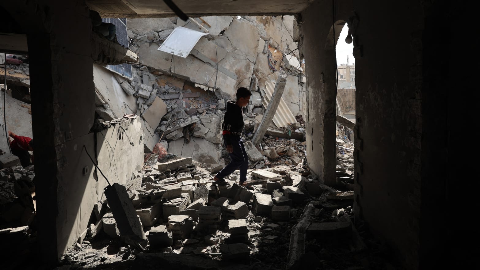 A Palestinian boy walks through the rubble following Israeli bombardment of Rafah's Tal al-Sultan district in the southern Gaza Strip on May 7, 2024.
