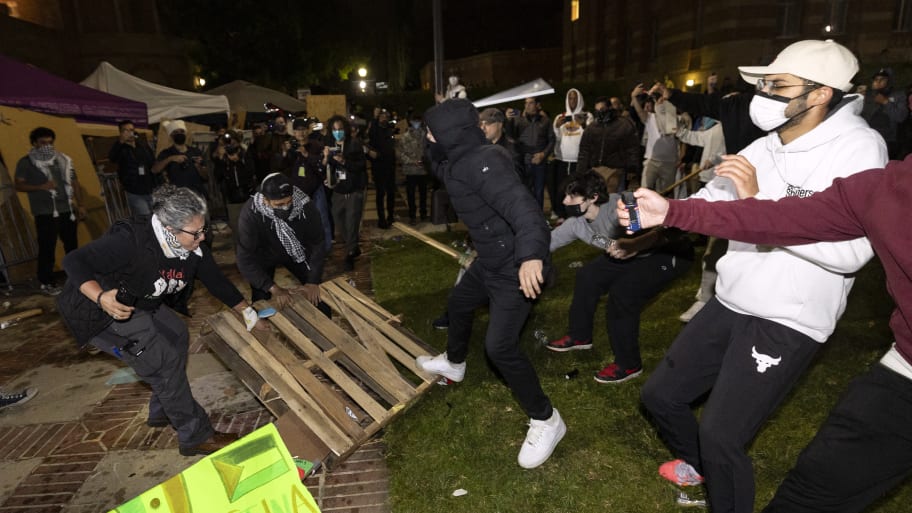 Counter protesters attack pro-Palestinian protesters at a pro-Palestinian encampment set up on the campus of the University of California Los Angeles (UCLA) as clashes erupt, in Los Angeles on May 1, 2024. 