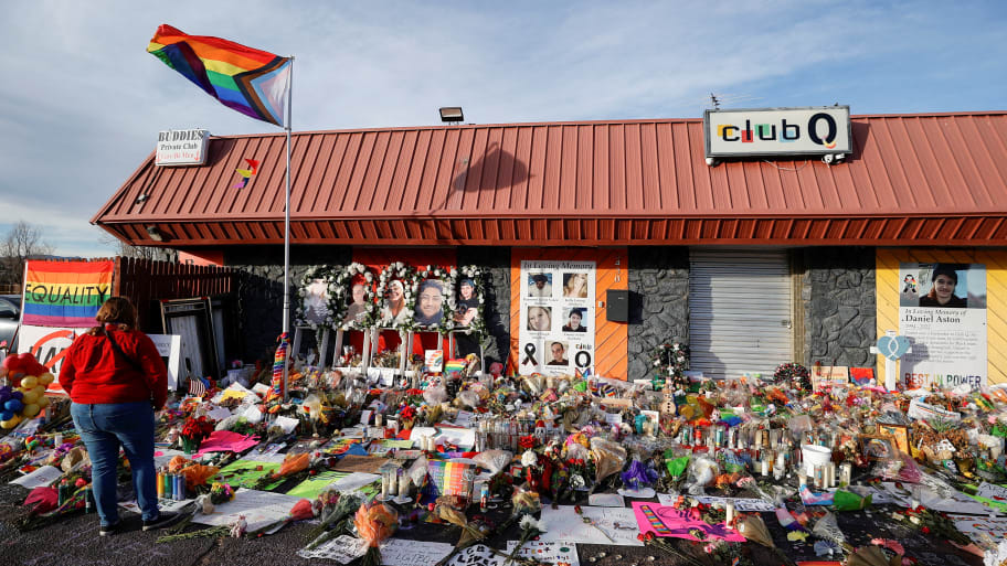 A person looks on at the flowers and mementos left at a memorial at Club Q after a mass shooting at the LGBTQ nightclub in Colorado Springs, Colorado, U.S. November 26, 2022.