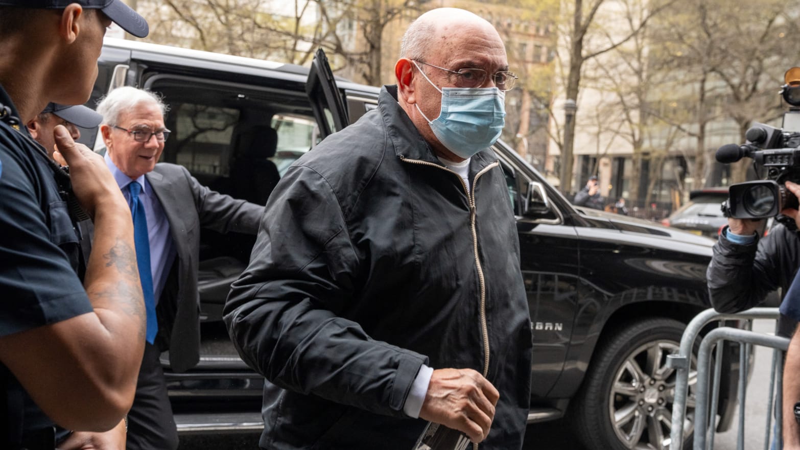 Allen Weisselberg, dressed in all black and wearing a surgical mask, walks into court.