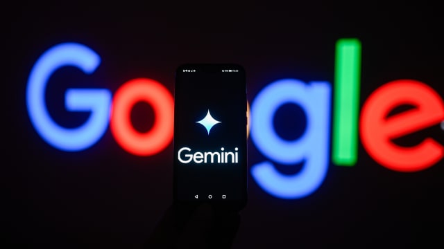 In this photo illustration a Google gemini logo is displayed on a smartphone with stock market percentages in the background. 