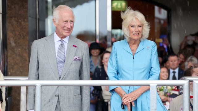 King Charles III and Queen Camilla watch The King’s Parade under torrential rain during an official visit to Jersey on July 15, 2024 in St Helier, Jersey.