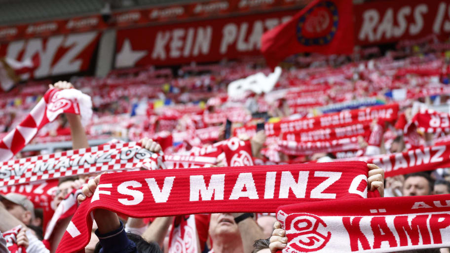 Fans of Mainz raise red and white scarfs in support of the club.