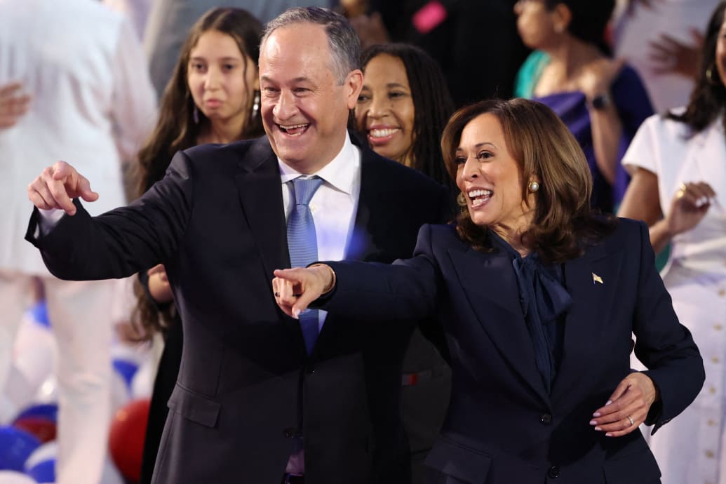 Kamala Harris celebrates on stage with her husband Doug Emhoff