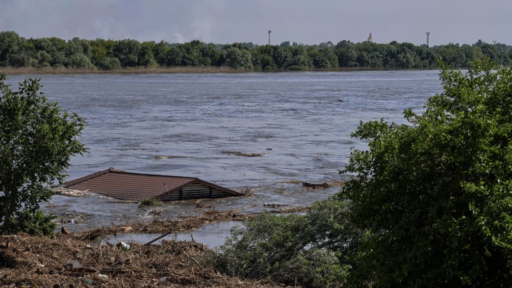 The roof of a house is seen in the Dnipro river which flooded after the Nova Kakhovka dam breached, amid Russia’s attack on Ukraine, in Kherson, Ukraine, June 6, 2023.