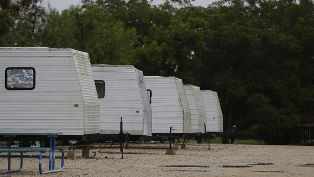 Lines of RVs sit in a partially empty RV park in Cuero, Texas Tuesday, July 26, 2016.