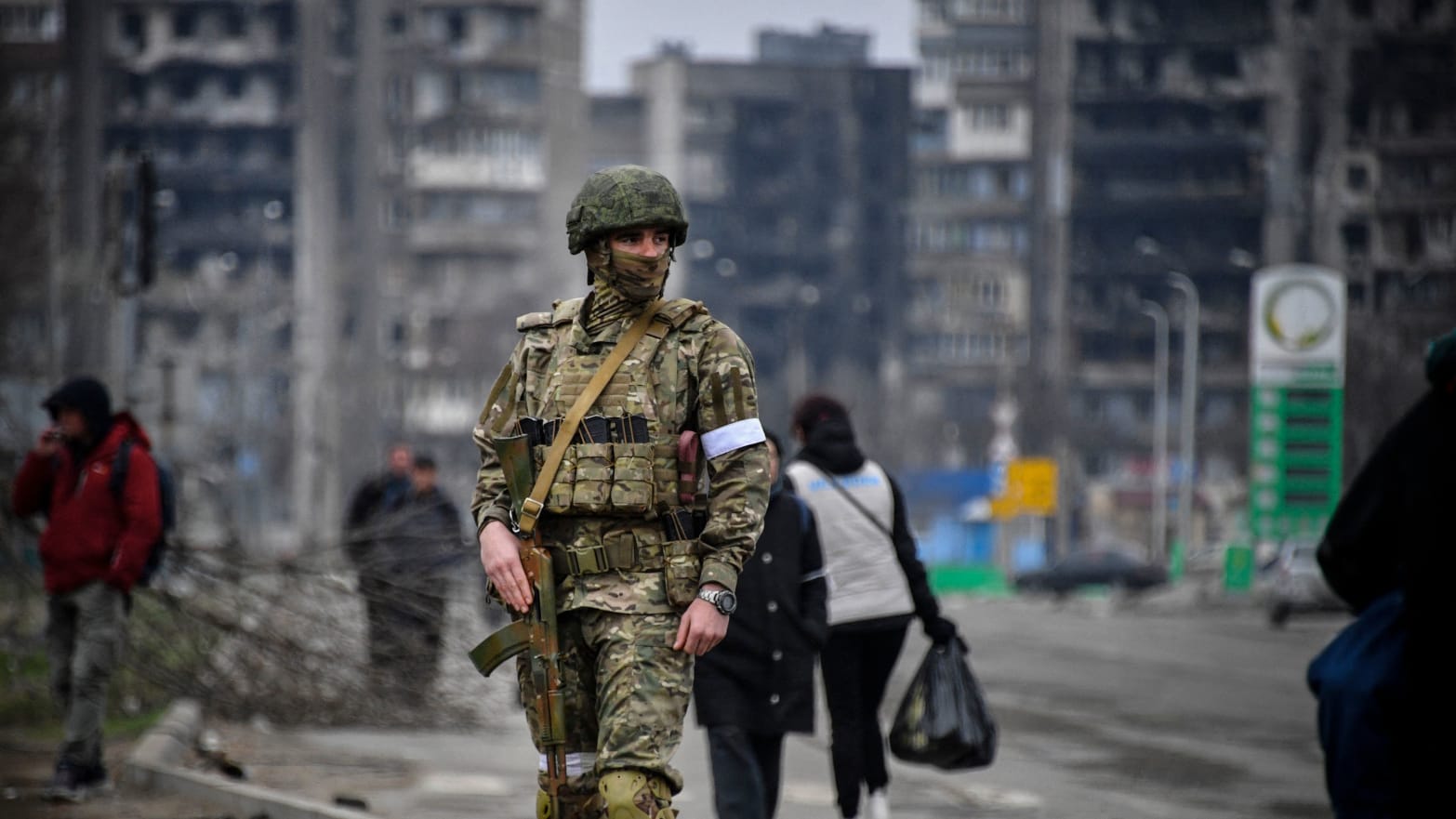 A Russian soldier patrols in a street of Mariupol 