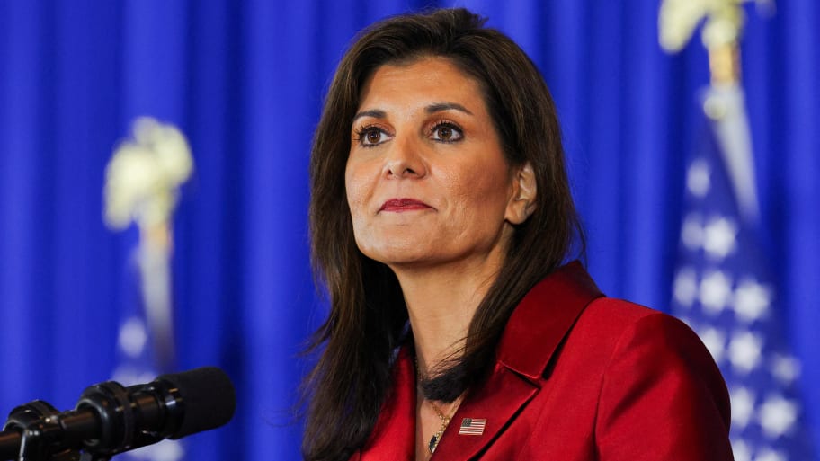 Nikki Haley stares forward while standing at a podium during a press conference.